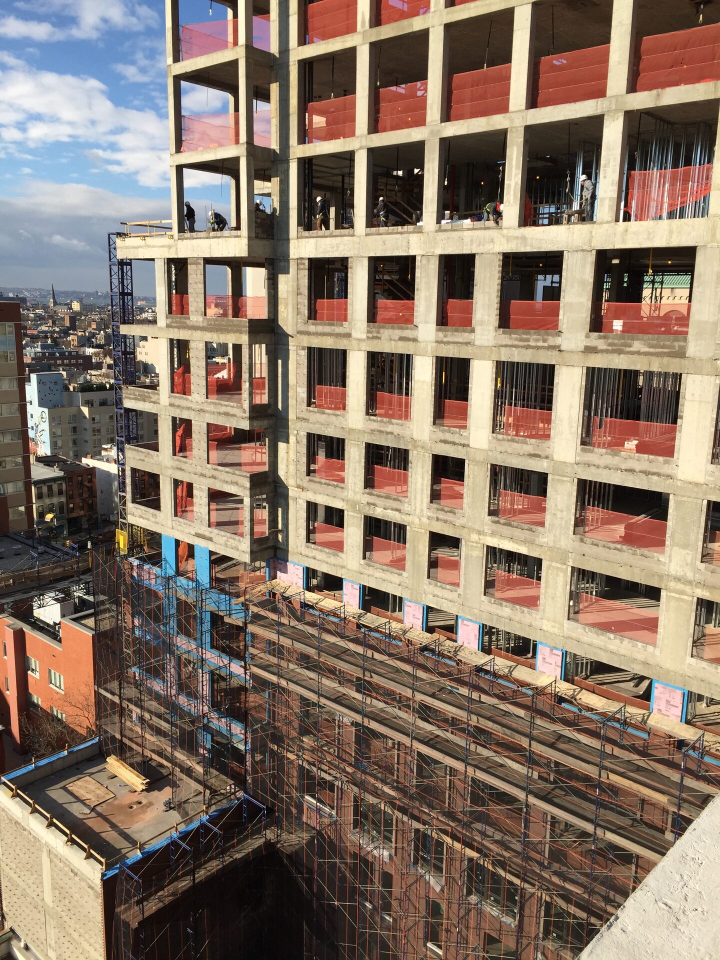 The Boerum — concrete superstructure rising above the subway tunnel, with brick infill in progress