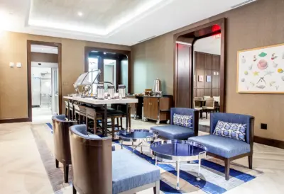 The Boerum — bar lounge with blue armchairs and patterned ceiling