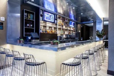 The Boerum — bar in evening light with wire stools