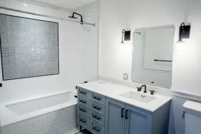 The Boerum — bathroom interior with subway-tile tub surround and gray vanity