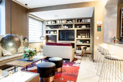 The Boerum — living room interior with built-in shelving, TV, and accent rug