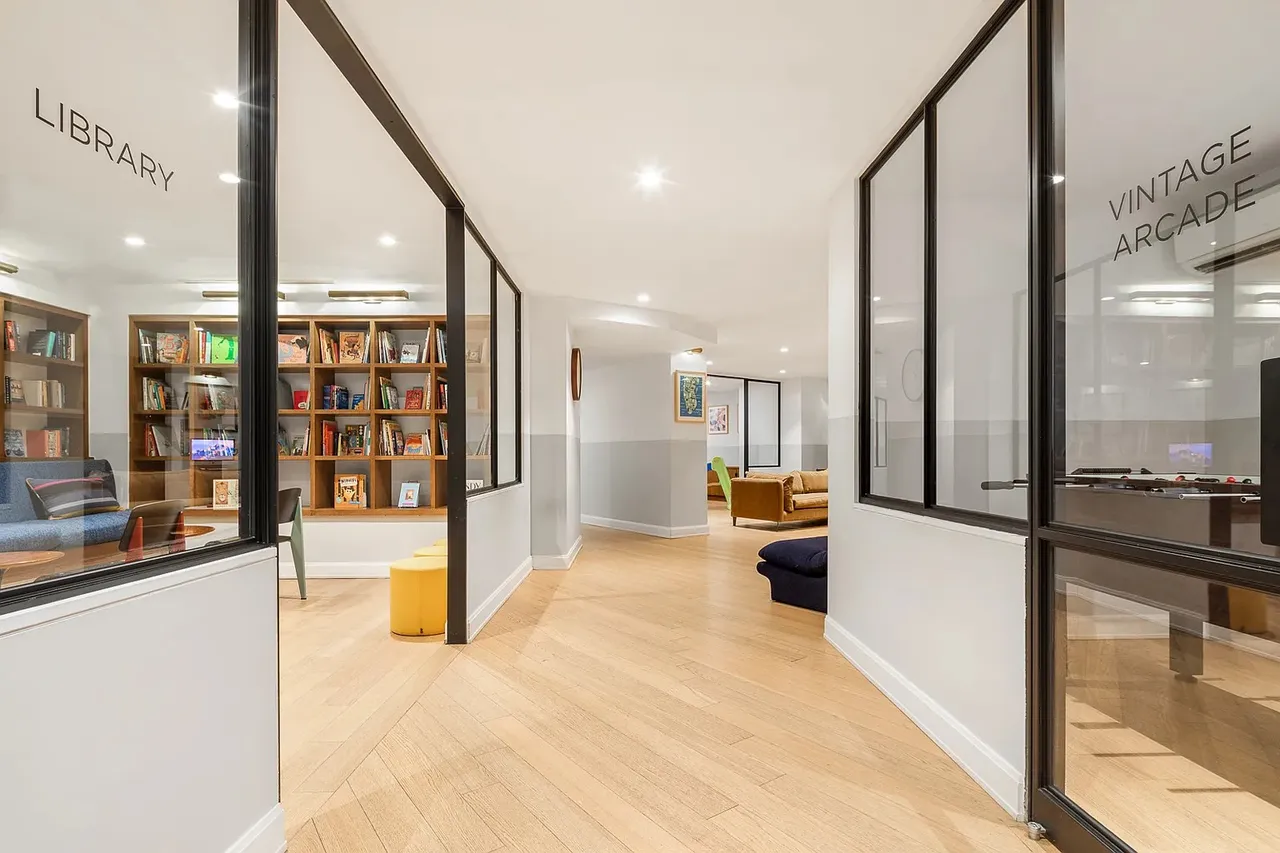 The Oriana — frosted-glass wayfinding for the Library and Vintage Arcade amenity rooms