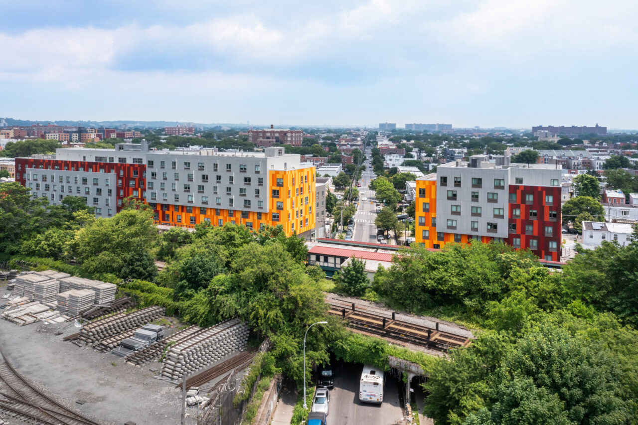 Van Sinderen Plaza — aerial view of the two-building development next to the rail line
