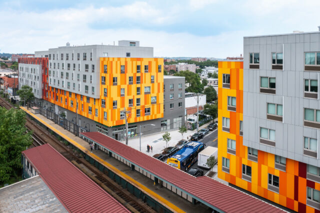 Van Sinderen Plaza — view from the elevated train station showing the orange-paneled facade and transit context
